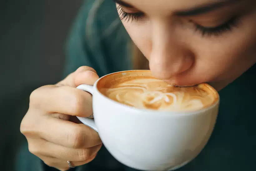 Girl drinking Cappuccino Coffee